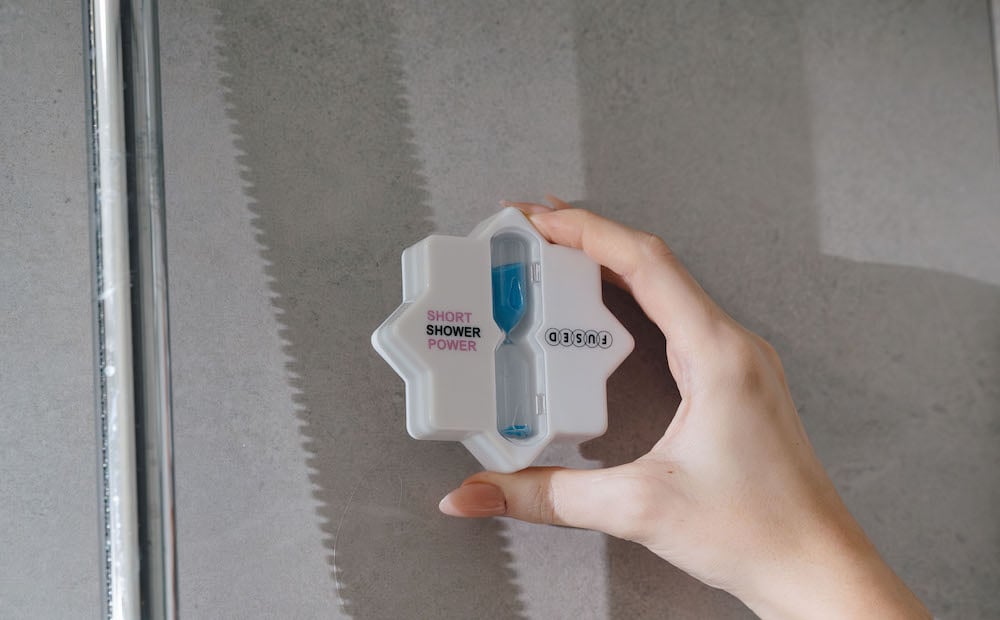 An image of a shower timer sticking to some tiles